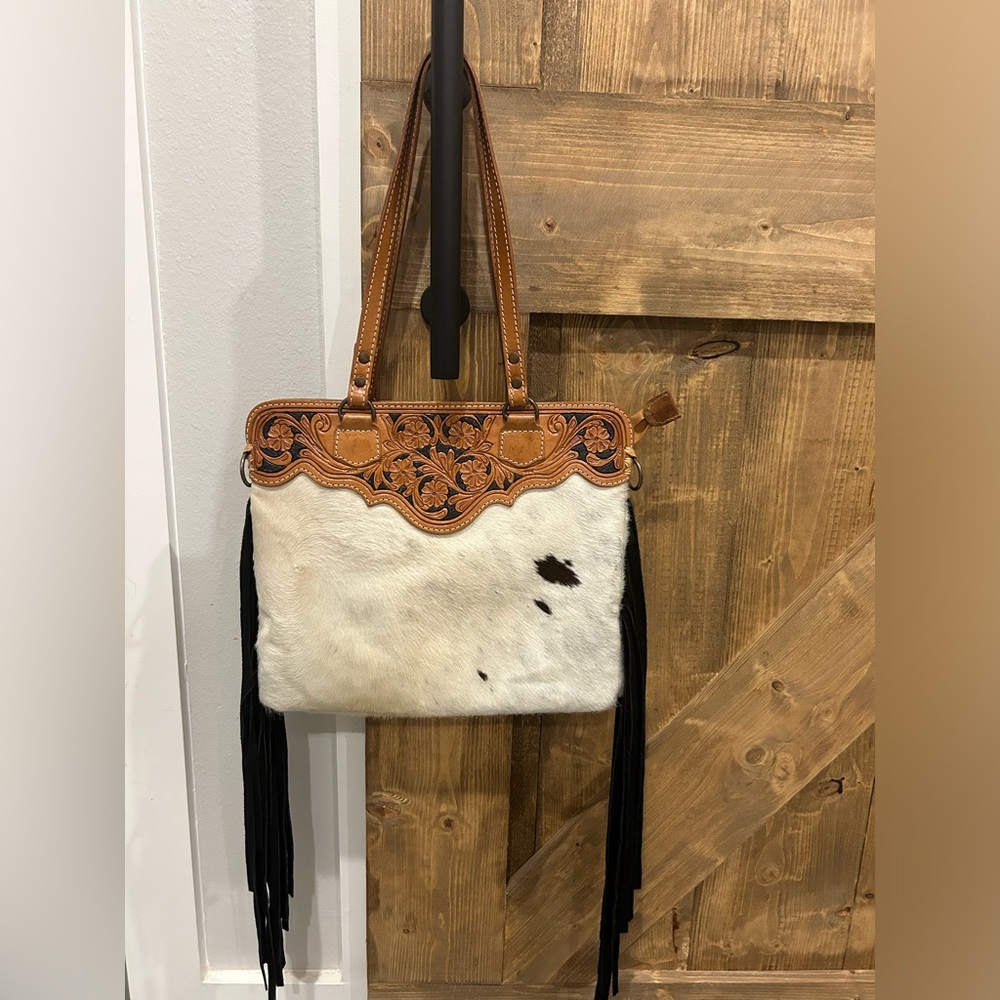 American Darling hand tootled hair on hide bag.